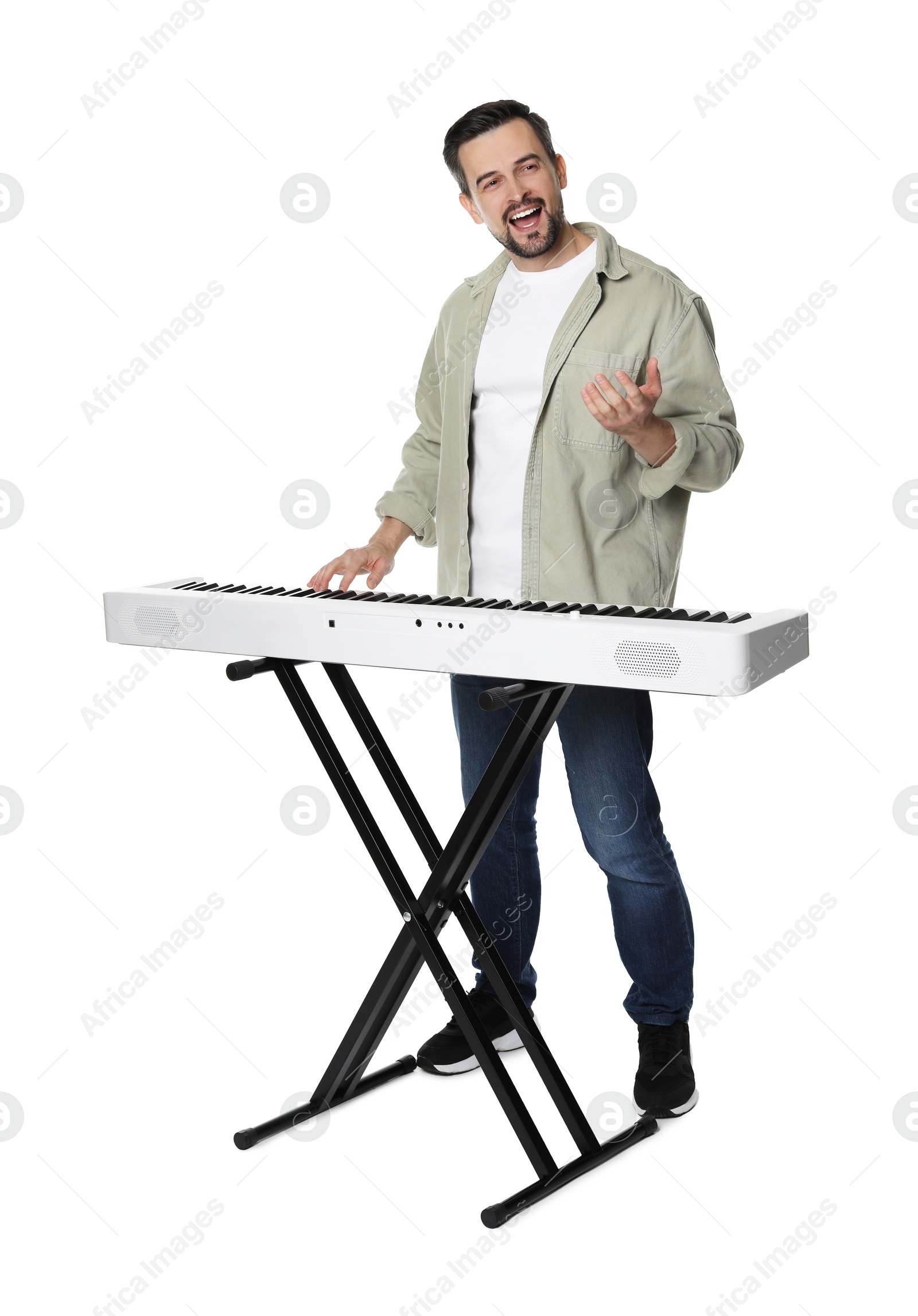 Photo of Smiling man playing synthesizer on white background