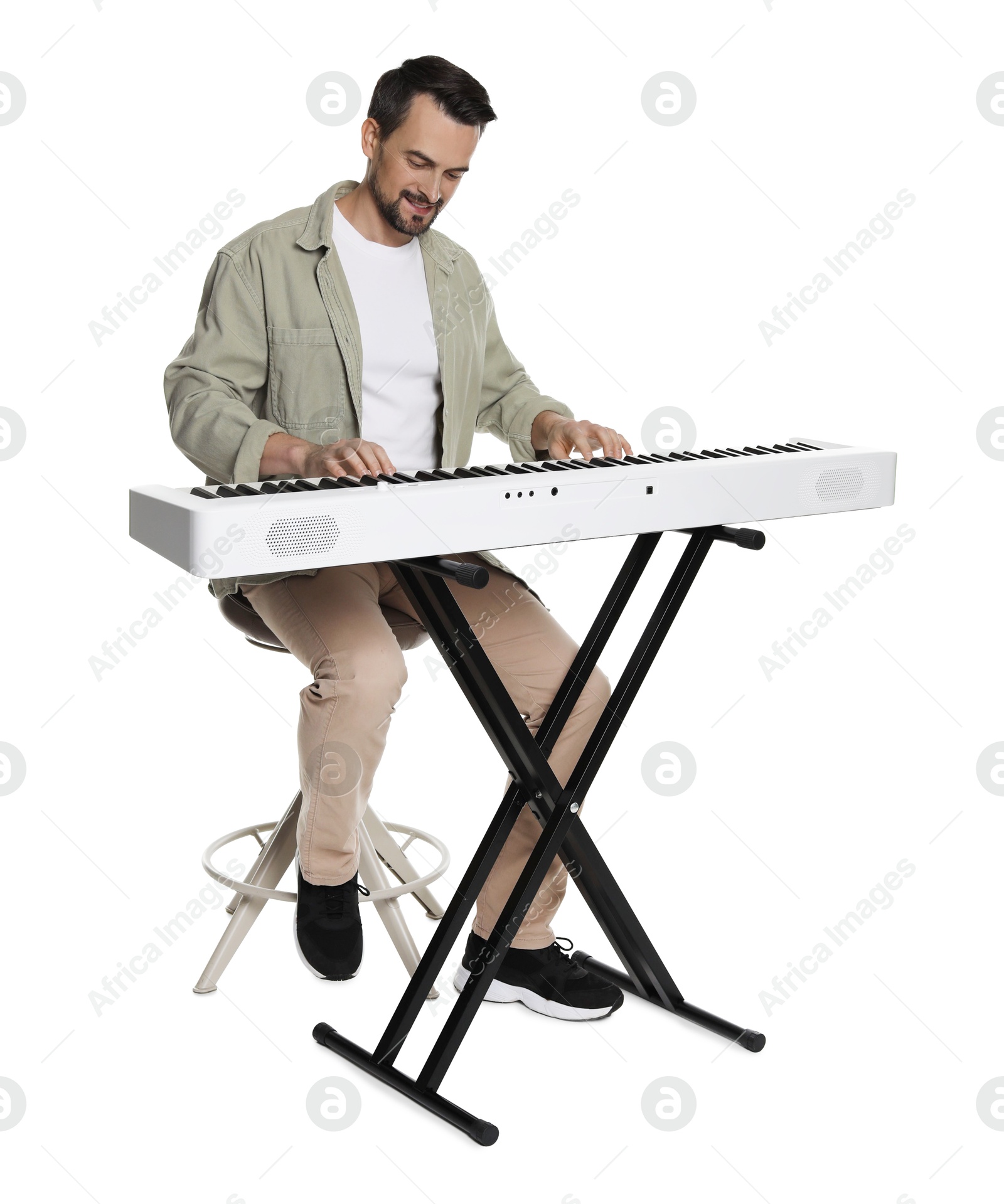 Photo of Bearded man playing synthesizer on white background