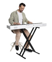 Photo of Bearded man playing synthesizer on white background