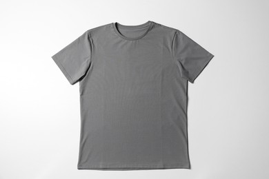 Photo of One blank t-shirt on white background, top view. Mockup for design