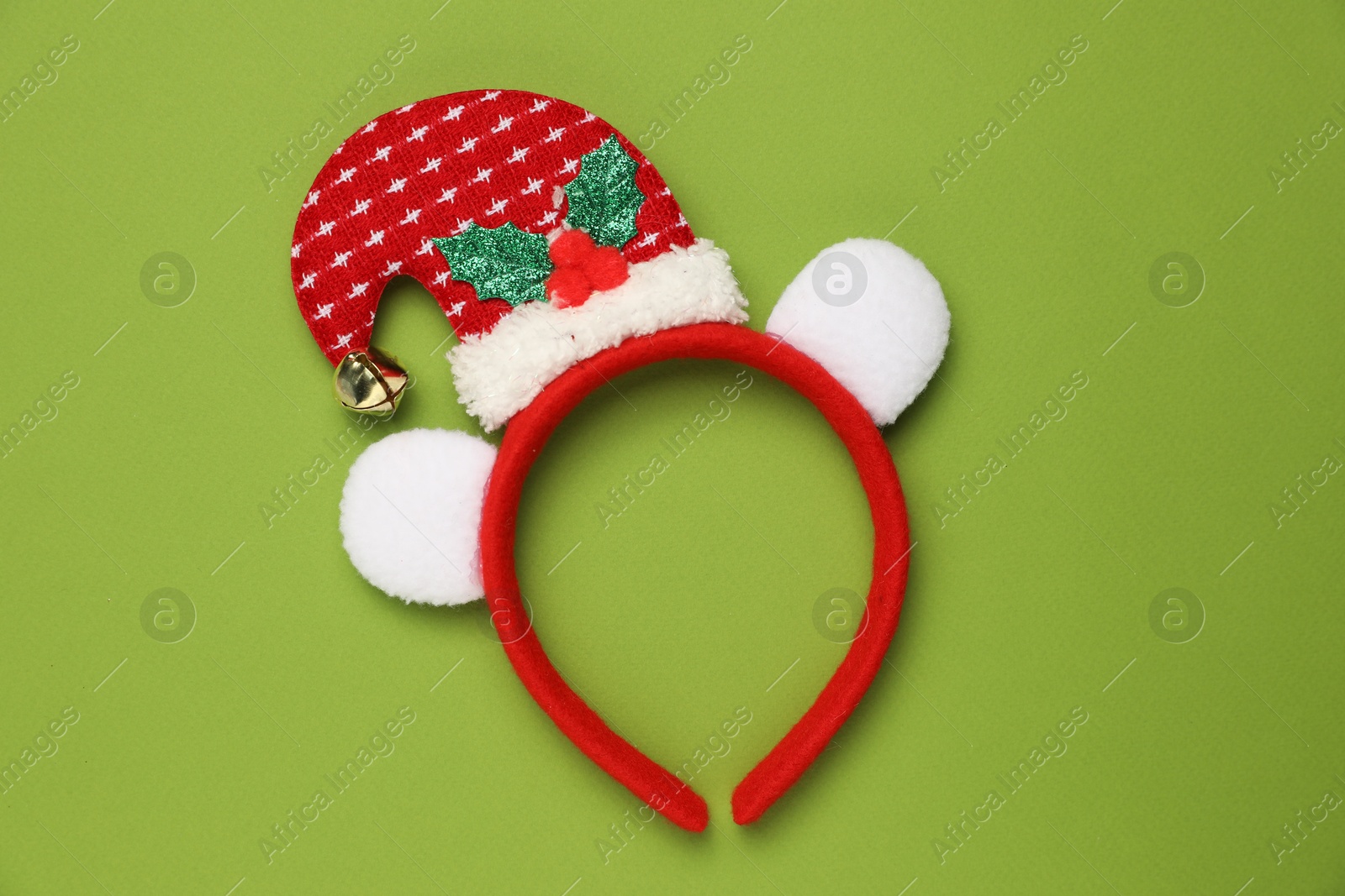 Photo of Stylish party headband on green background, top view. Christmas accessory