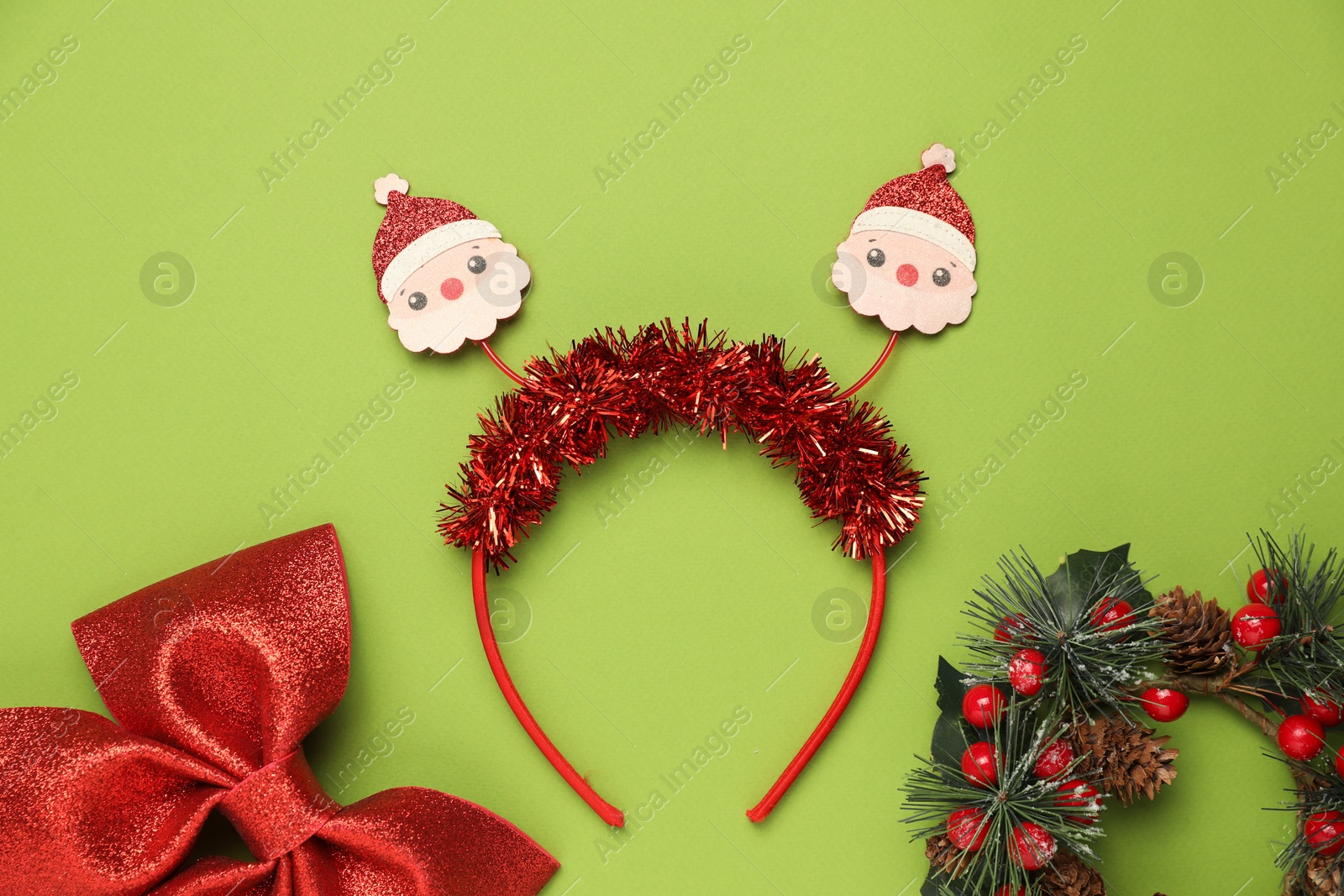 Photo of Stylish party headband and Christmas decor on green background, flat lay