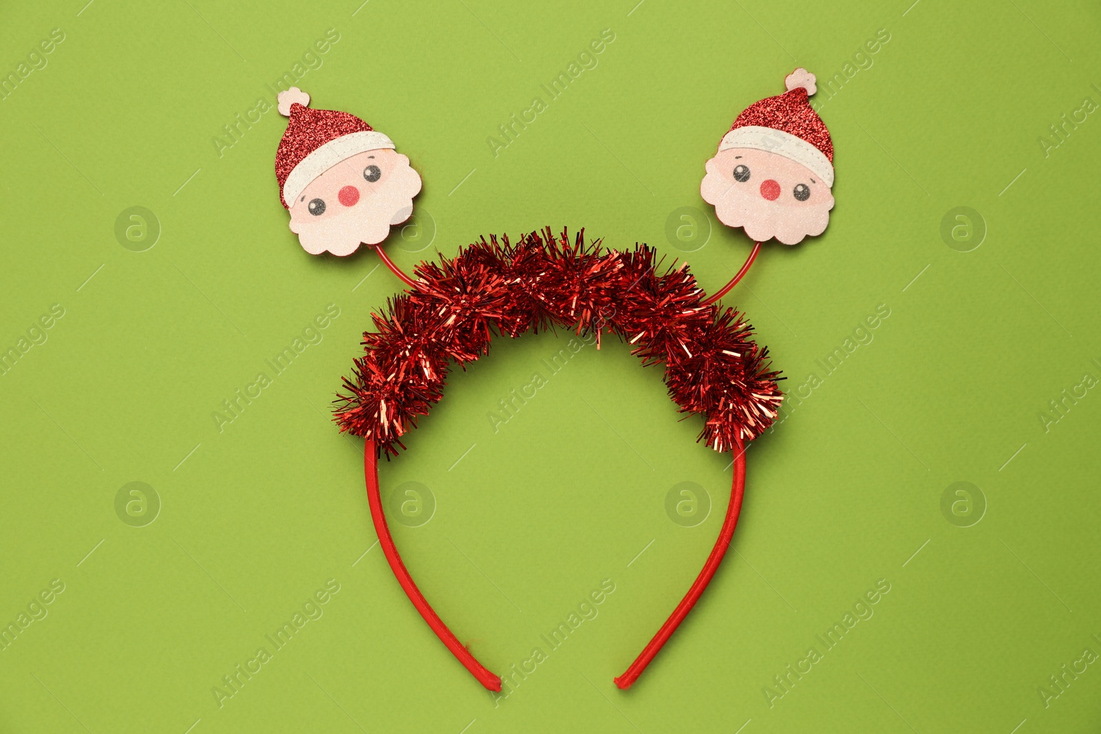 Photo of Stylish party headband on green background, top view. Christmas accessory