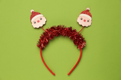 Stylish party headband on green background, top view. Christmas accessory