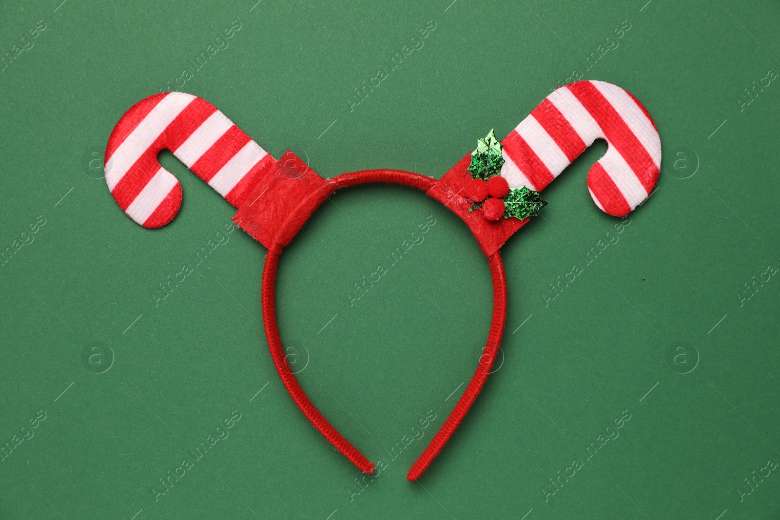 Photo of Stylish party headband on green background, top view. Christmas accessory