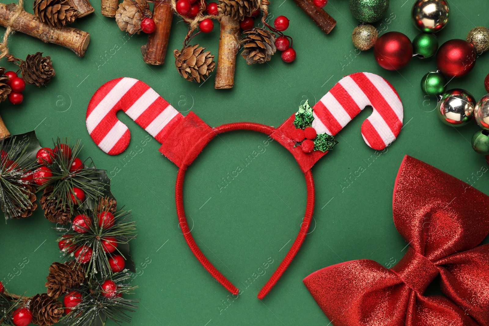 Photo of Stylish party headband and Christmas decor on green background, flat lay