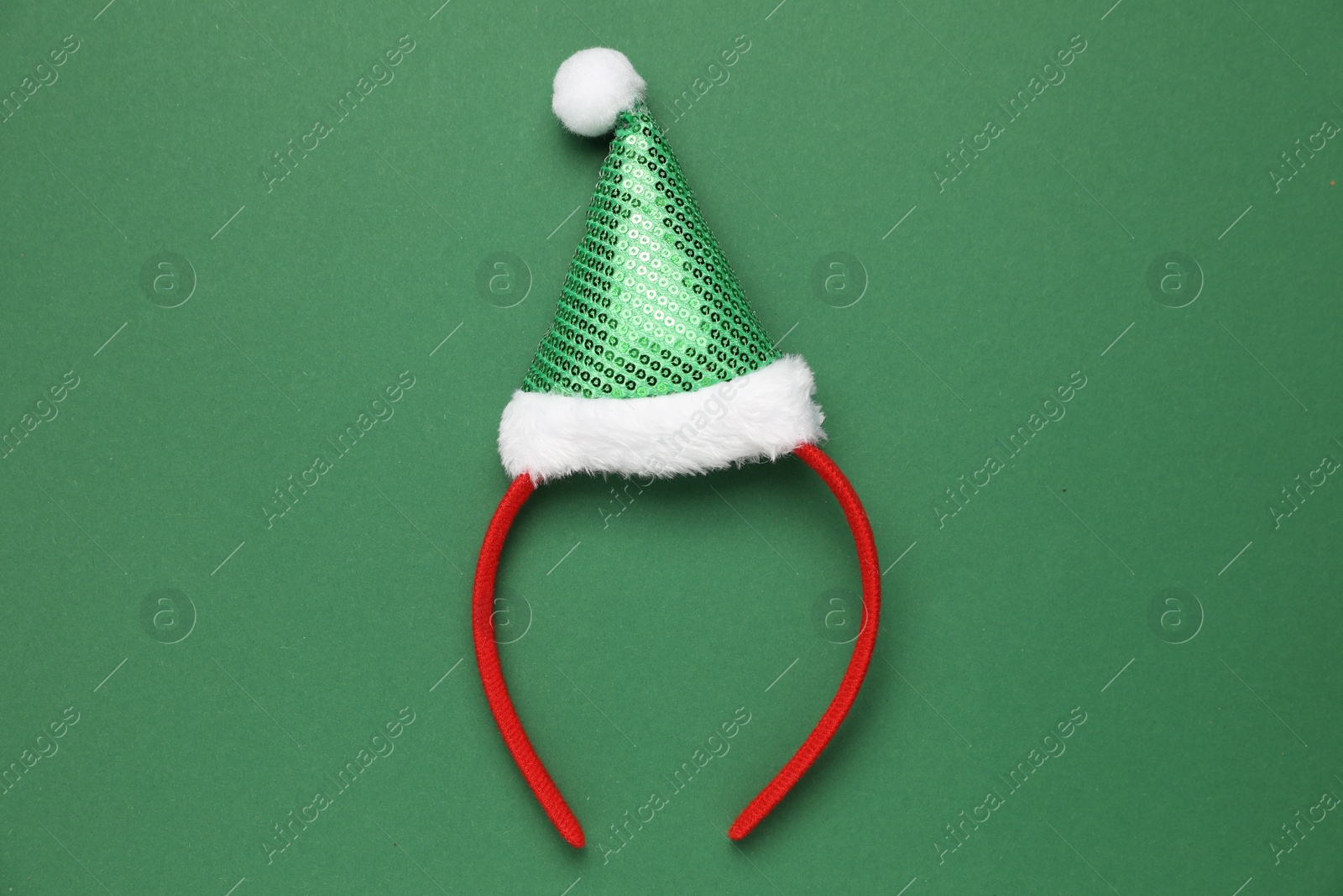 Photo of Stylish party headband on green background, top view. Christmas accessory