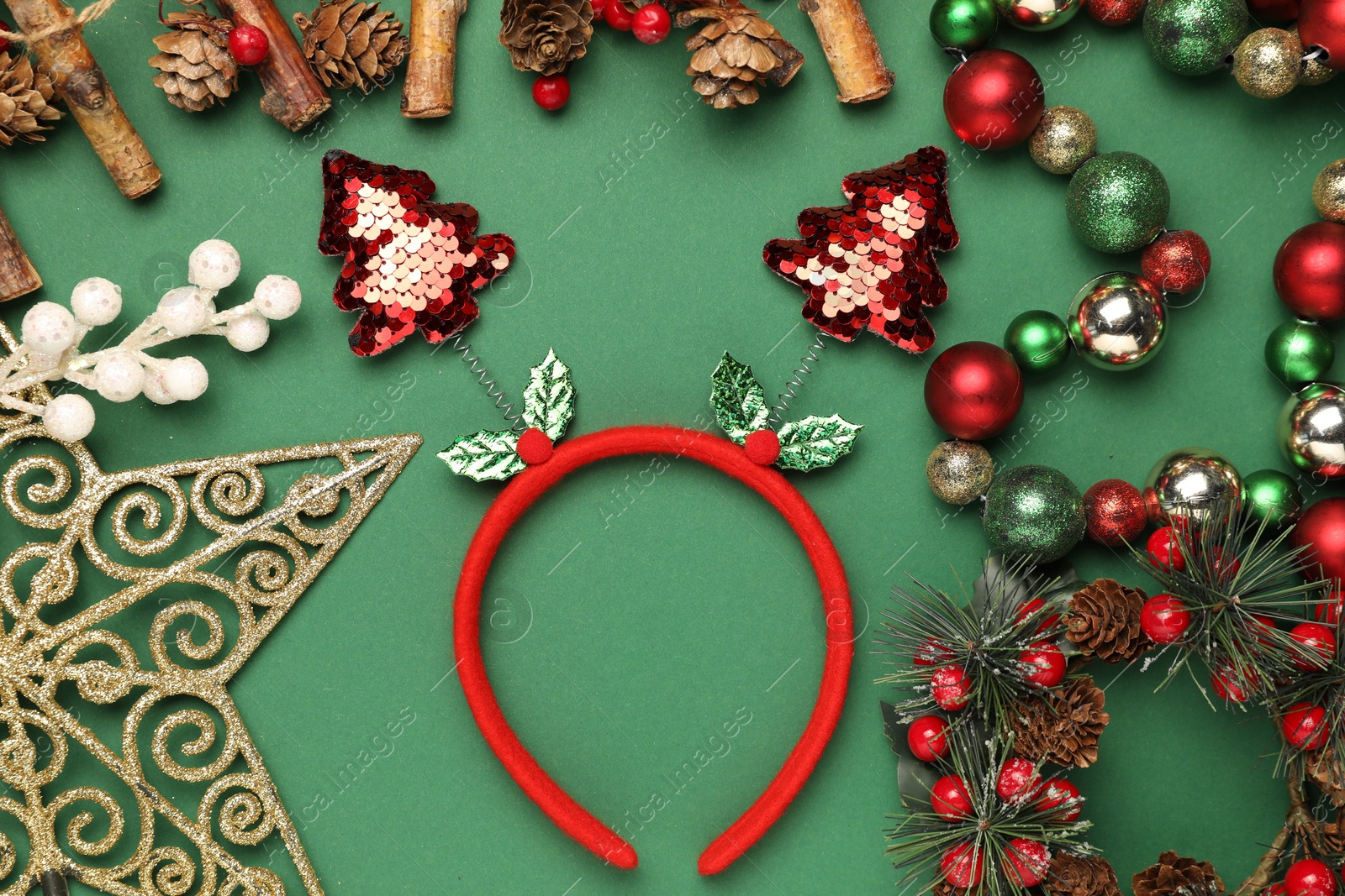 Photo of Stylish party headband and Christmas decor on green background, flat lay