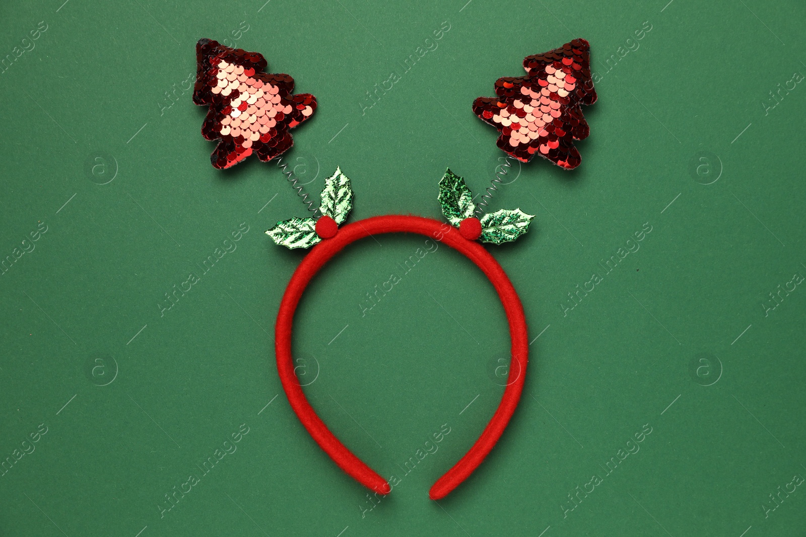 Photo of Stylish party headband on green background, top view. Christmas accessory