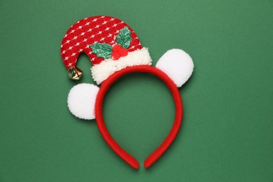 Photo of Stylish party headband on green background, top view. Christmas accessory