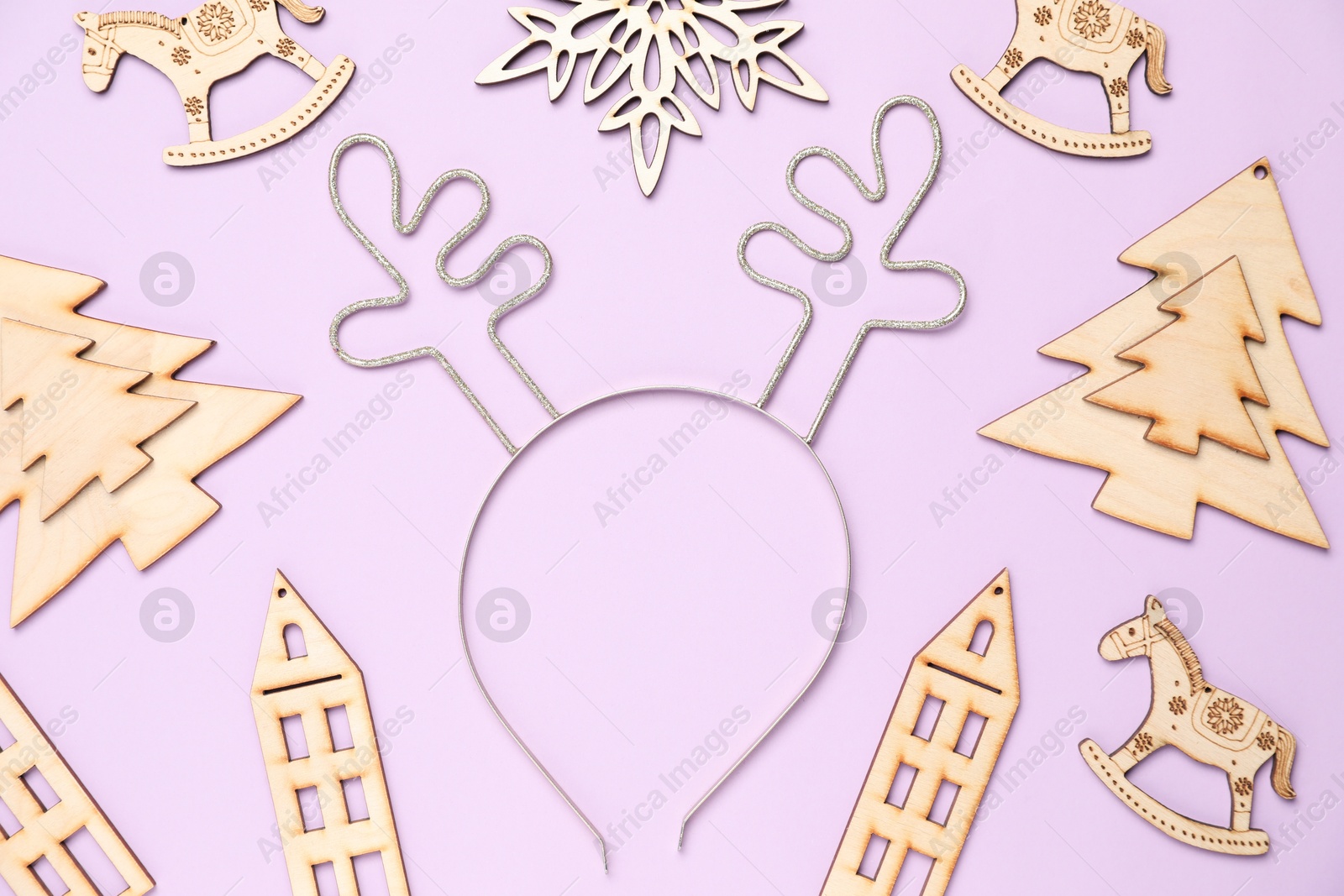 Photo of Beautiful reindeer headband and Christmas decor on lilac background, flat lay