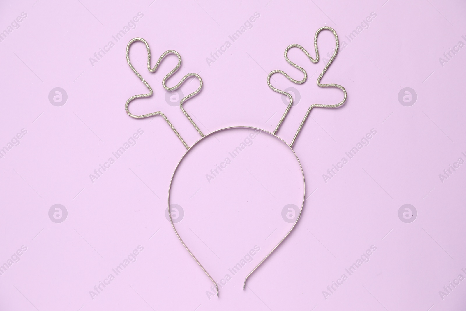 Photo of Beautiful reindeer headband on lilac background, top view. Christmas accessory