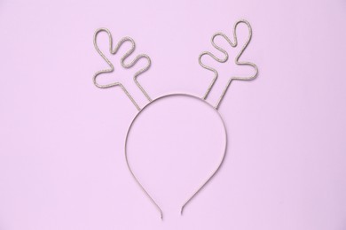 Beautiful reindeer headband on lilac background, top view. Christmas accessory