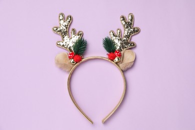 Beautiful reindeer headband on lilac background, top view. Christmas accessory