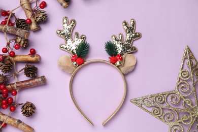 Photo of Beautiful reindeer headband and Christmas decor on lilac background, flat lay