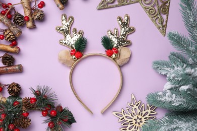 Photo of Beautiful reindeer headband and Christmas decor on lilac background, flat lay