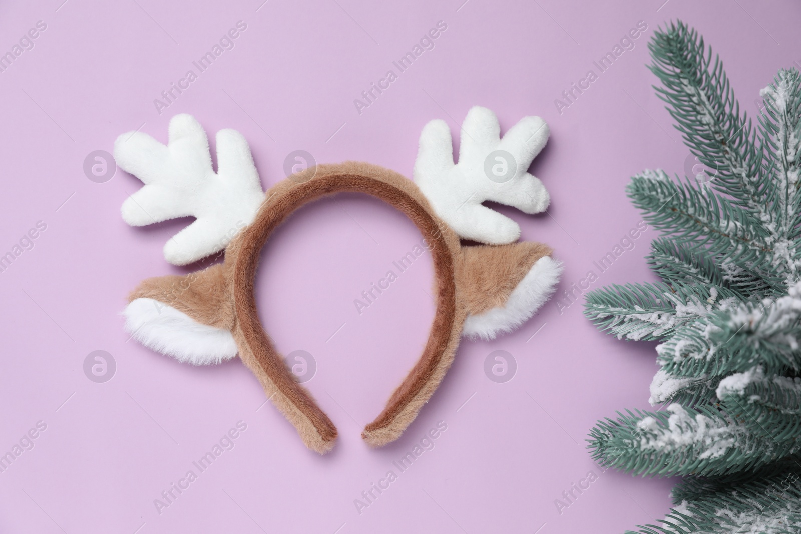 Photo of Beautiful reindeer headband and fir tree on lilac background, top view. Christmas accessory