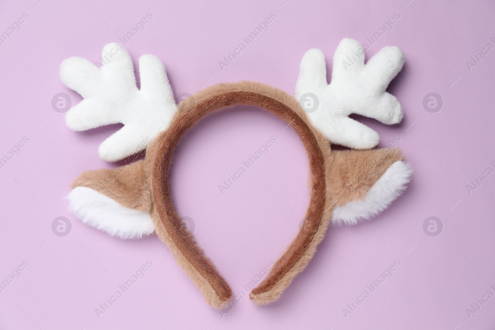 Photo of Beautiful reindeer headband on lilac background, top view. Christmas accessory