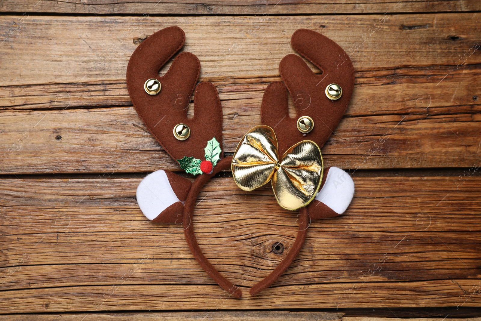 Photo of Beautiful reindeer headband on wooden background, top view. Christmas accessory