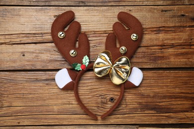 Beautiful reindeer headband on wooden background, top view. Christmas accessory