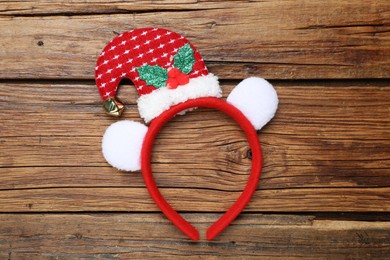 Photo of Stylish party headband on wooden background, top view. Christmas accessory