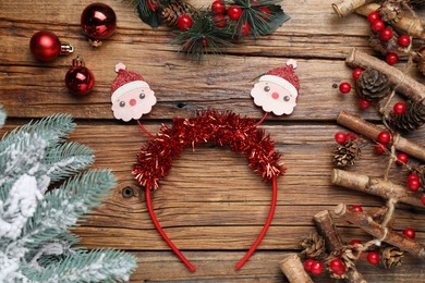 Photo of Stylish party headband and Christmas decor on wooden background, flat lay