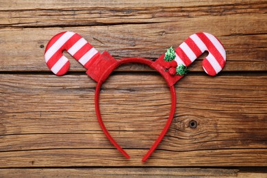 Photo of Stylish party headband on wooden background, top view. Christmas accessory