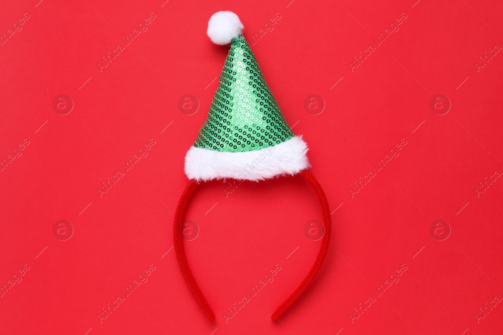 Photo of Stylish party headband on red background, top view. Christmas accessory