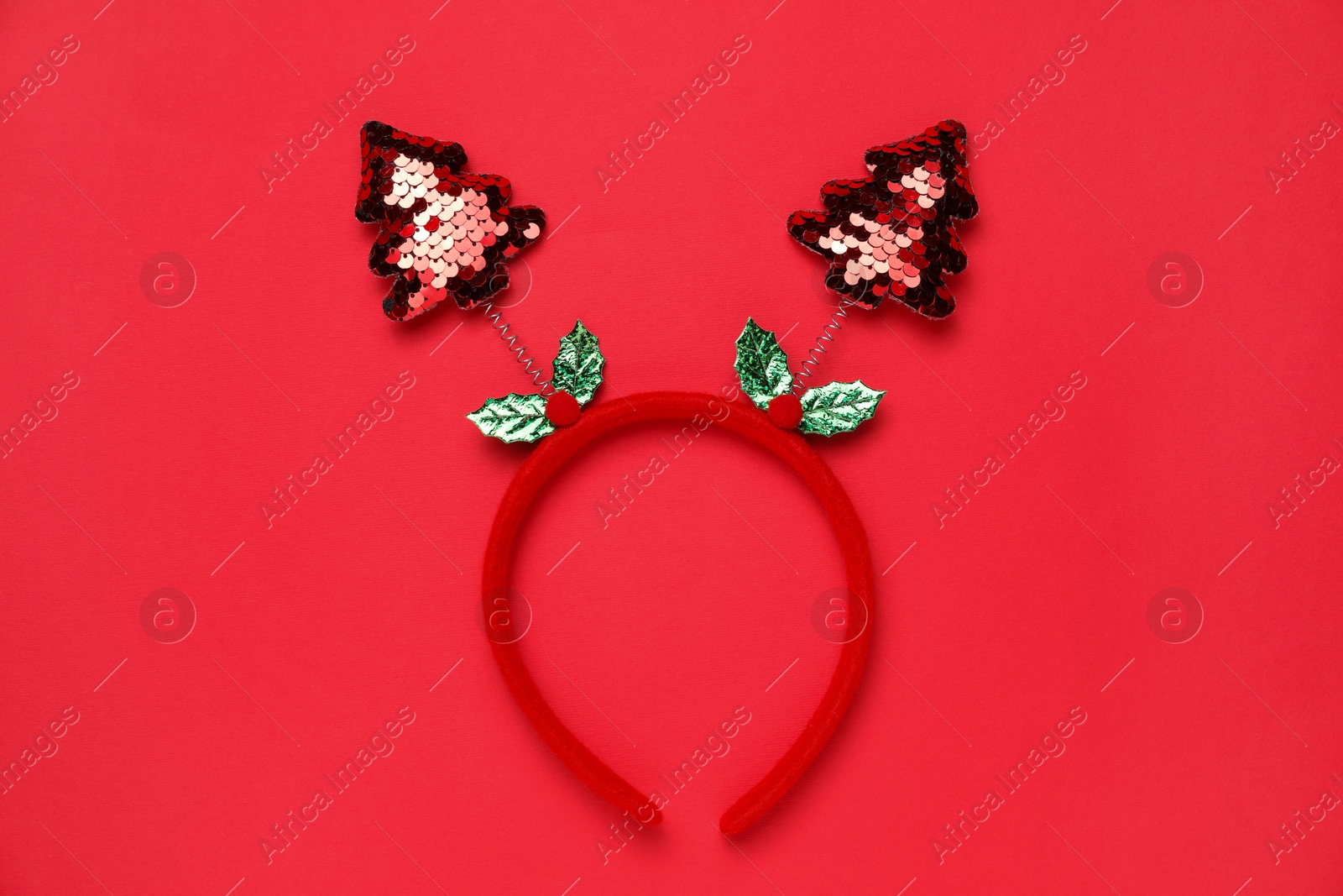 Photo of Stylish party headband on red background, top view. Christmas accessory