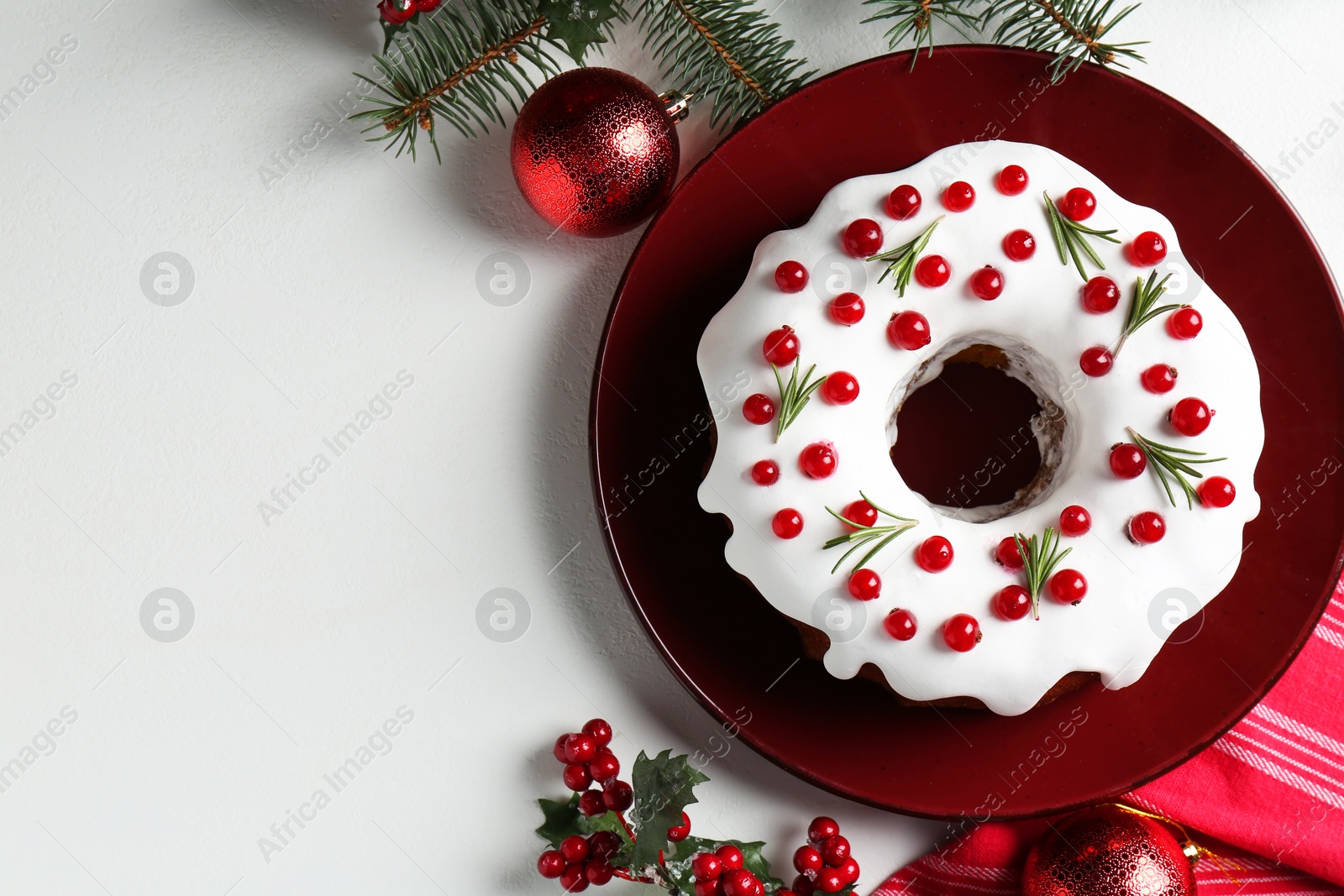 Photo of Traditional classic Christmas cake and decor on white table, flat lay. Space for text