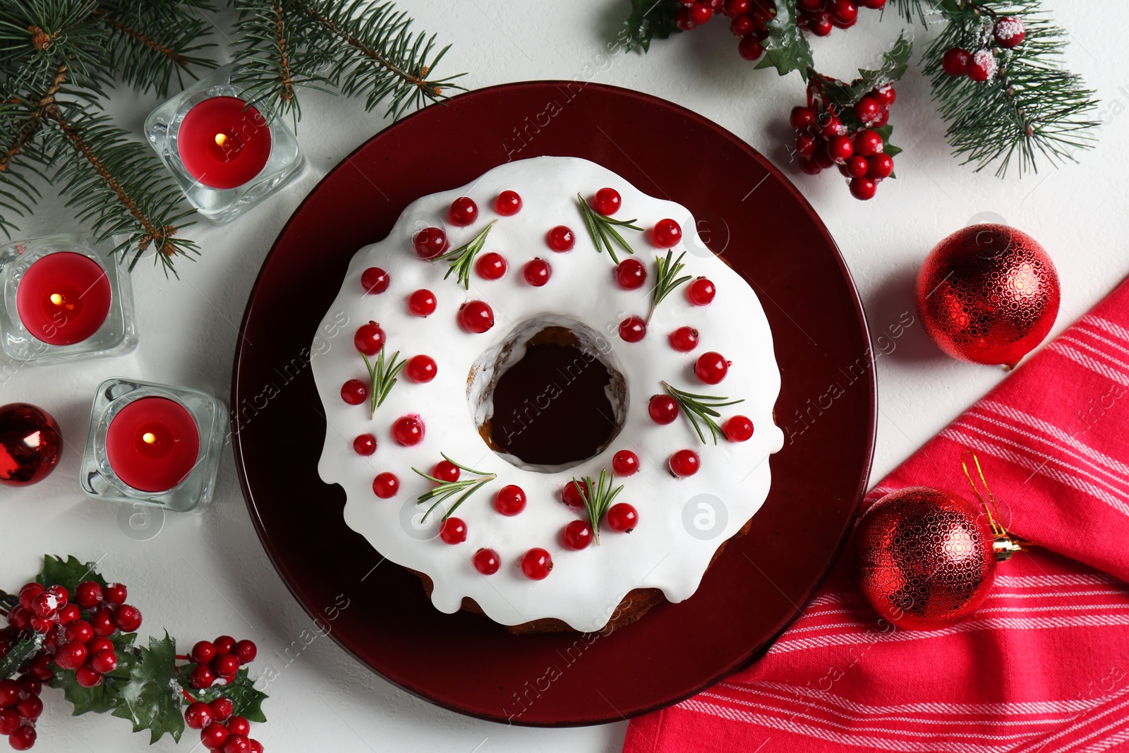 Photo of Traditional classic Christmas cake and decor on white table, flat lay