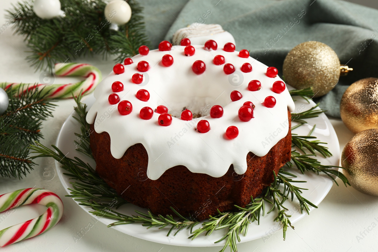 Photo of Traditional classic Christmas cake and decor on white table, closeup