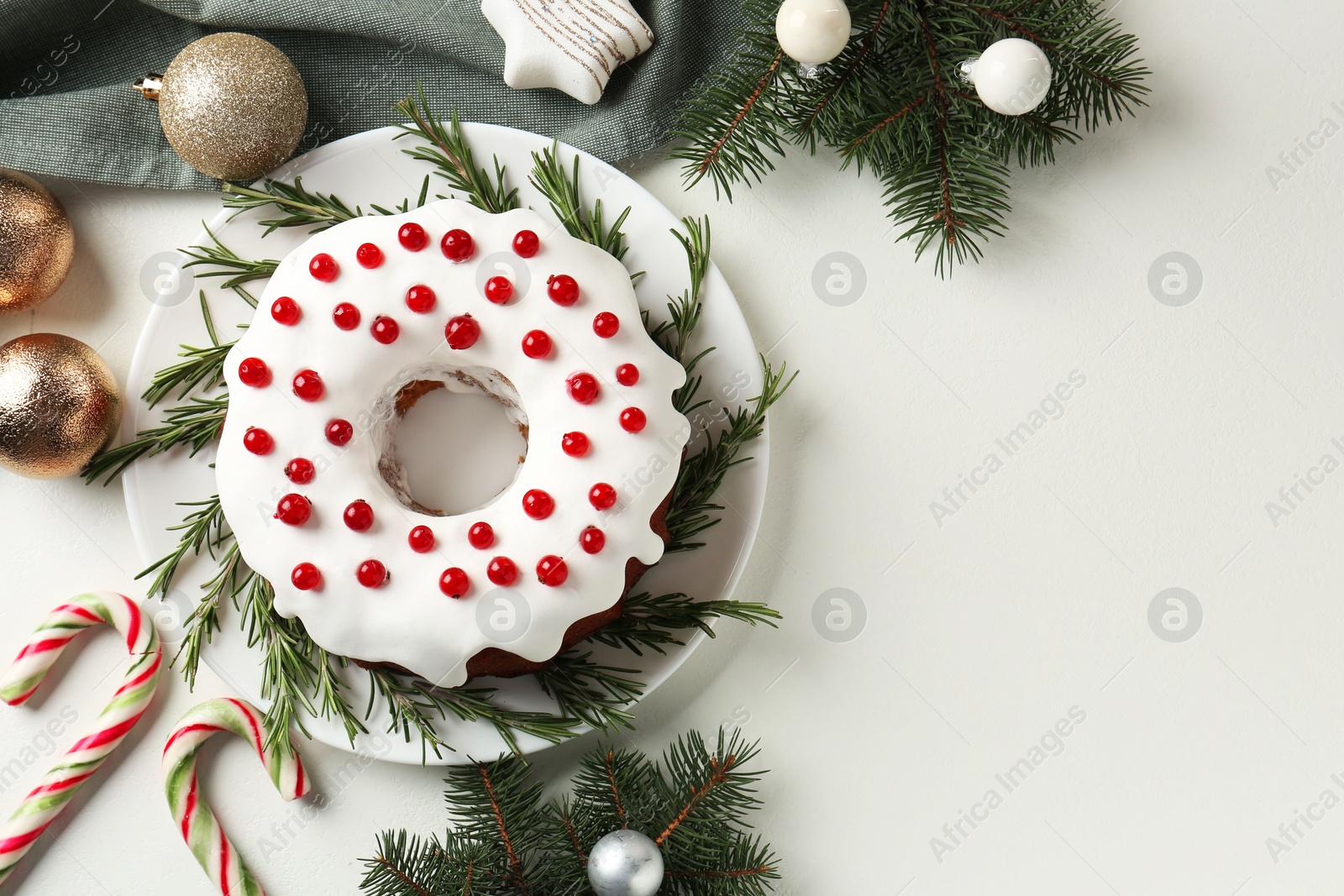 Photo of Traditional classic Christmas cake and decor on white table, flat lay. Space for text