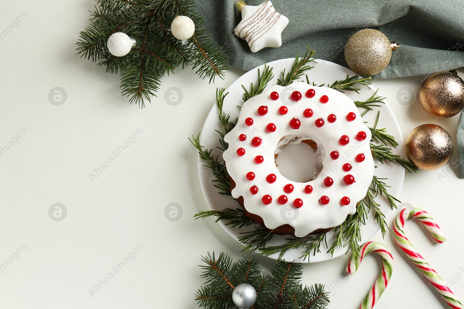 Photo of Traditional classic Christmas cake and decor on white table, flat lay. Space for text