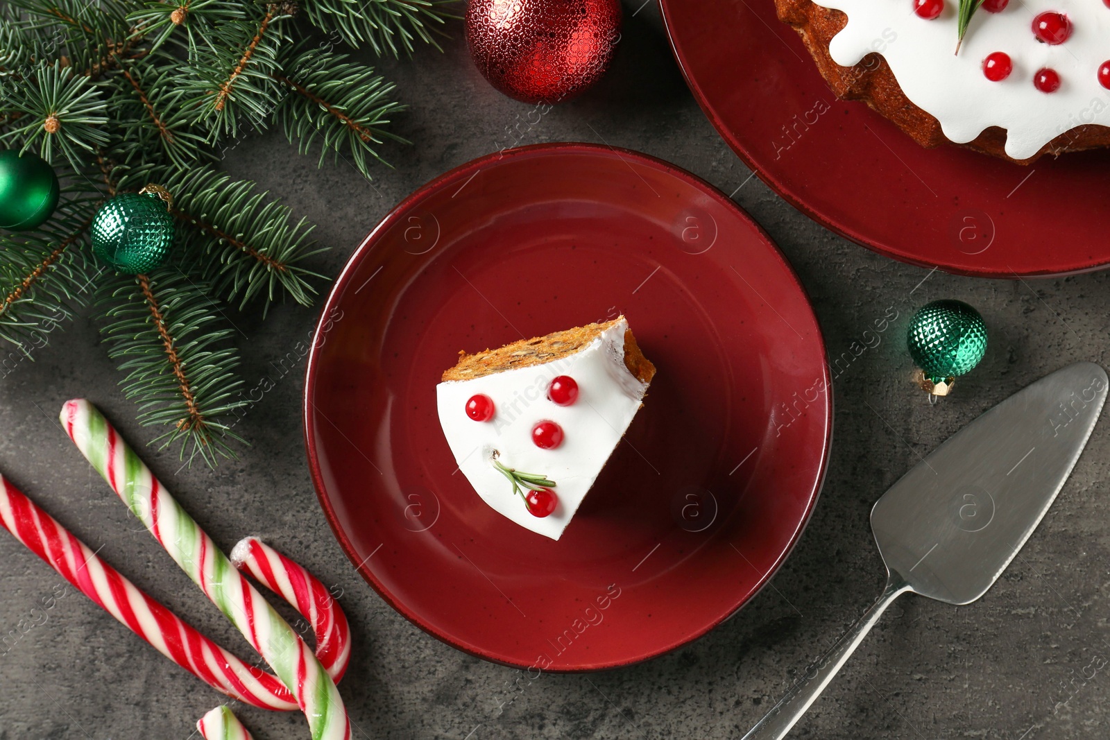 Photo of Traditional classic Christmas cake, decor and cake server on gray textured table, flat lay