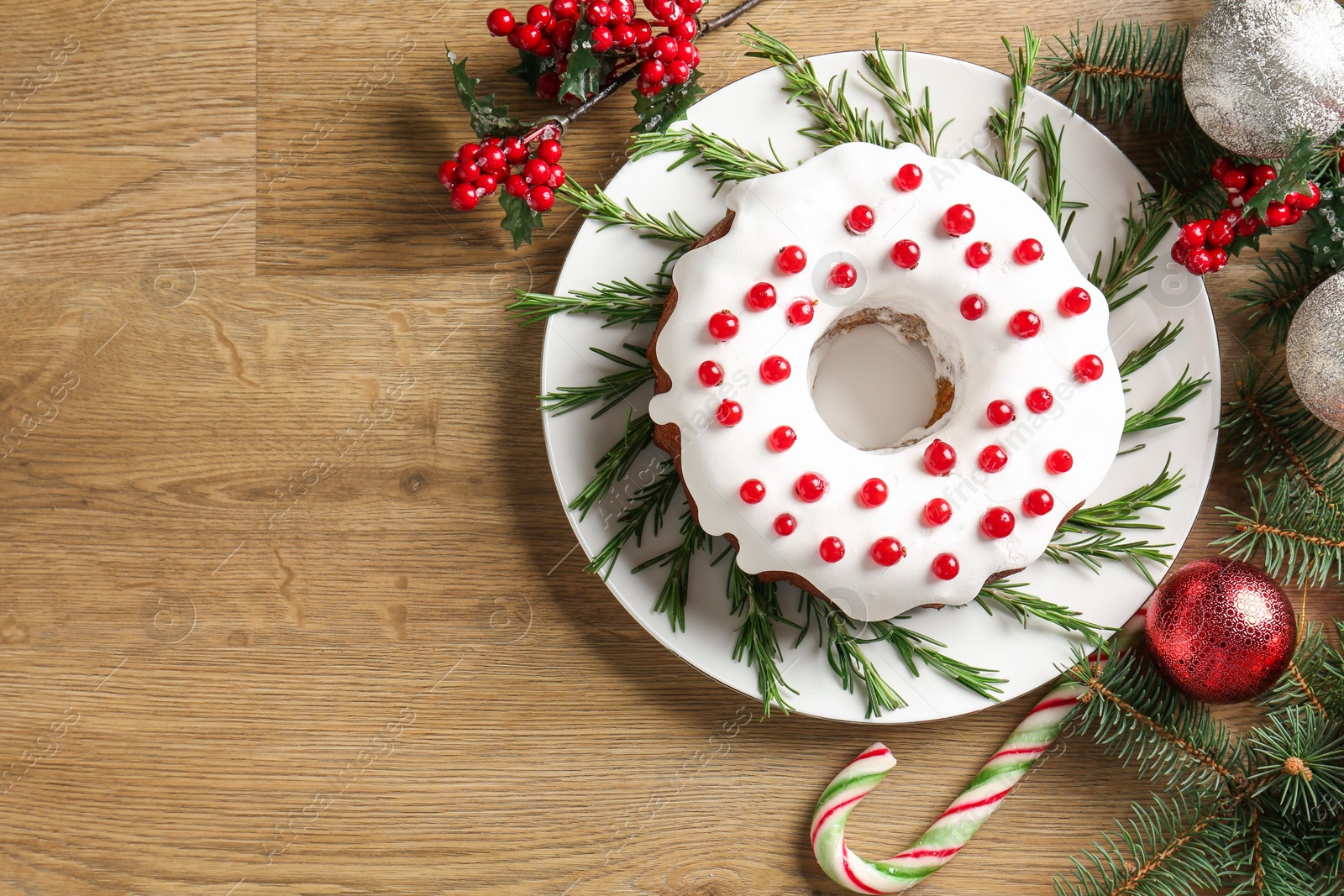 Photo of Traditional classic Christmas cake and decor on wooden table, flat lay. Space for text