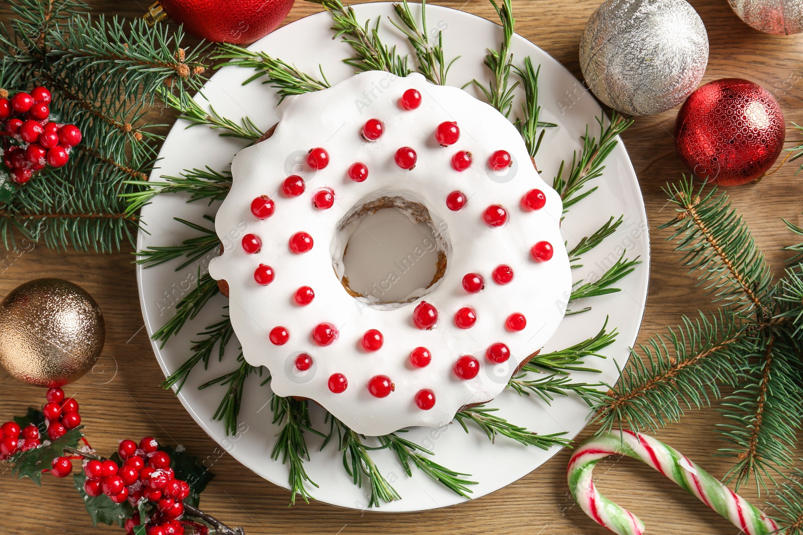 Photo of Traditional classic Christmas cake and decor on wooden table, flat lay