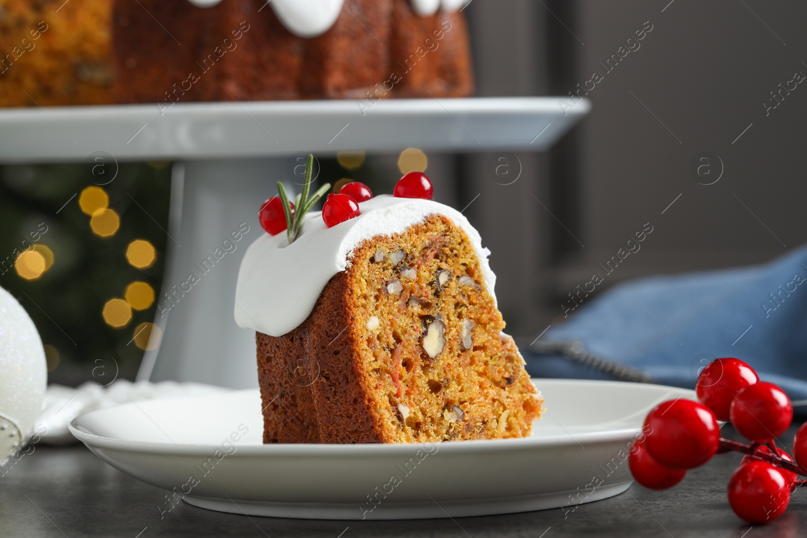 Photo of Piece of traditional classic Christmas cake on gray table, closeup