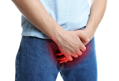 Image of STD (sexually transmitted diseases). Man holding hands near his groin on white background, closeup