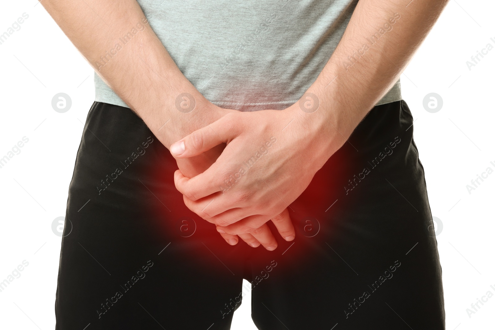 Image of STD (sexually transmitted diseases). Man holding hands near his groin on white background, closeup