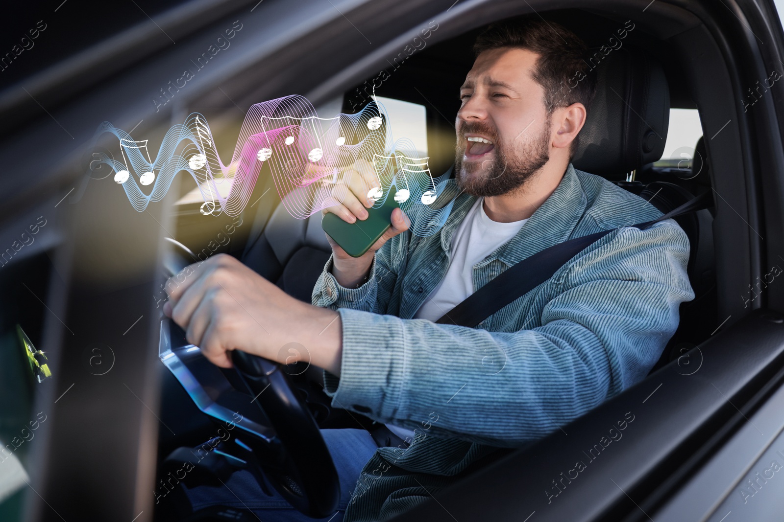 Image of Man with smartphone singing in car, view from outside. Music notes flying out of his mouth