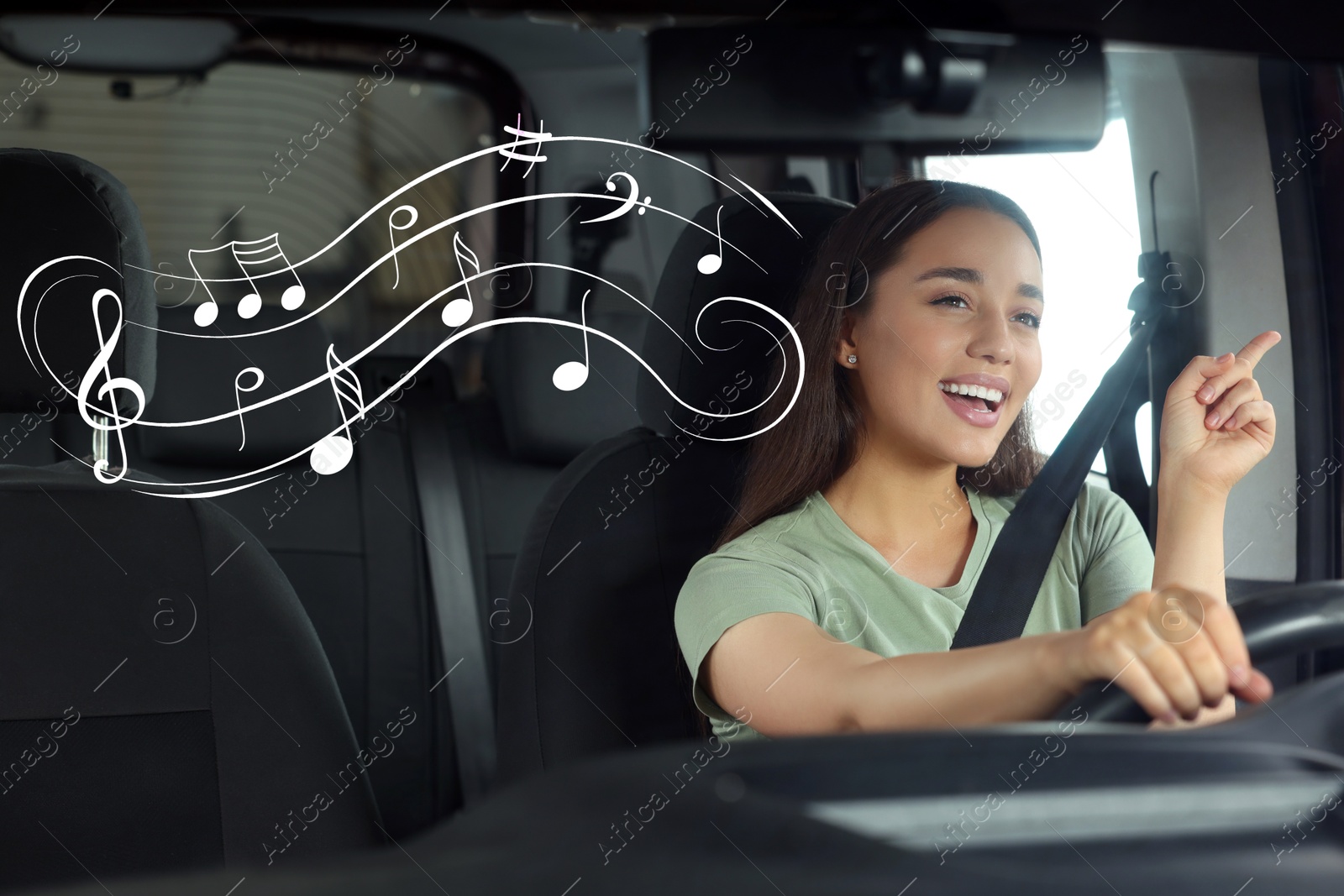 Image of Beautiful woman singing in car, view through windshield. Music notes flying near her