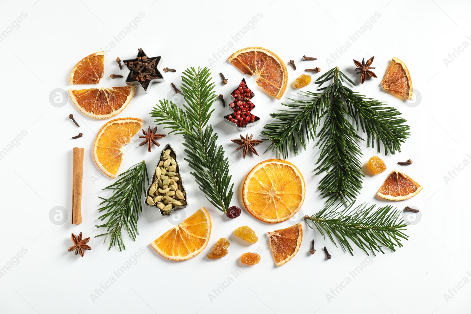 Photo of Different spices, dried orange slices and fir tree branches on white table, flat lay. Christmas season