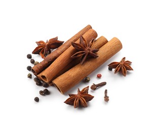 Photo of Different aromatic spices isolated on white. Christmas season