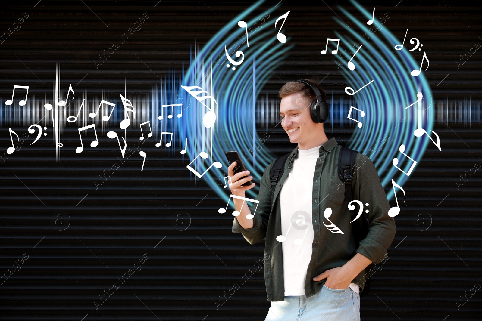 Image of Smiling man with headphones using smartphone near shutters outdoors. Music notes and sound waves near him