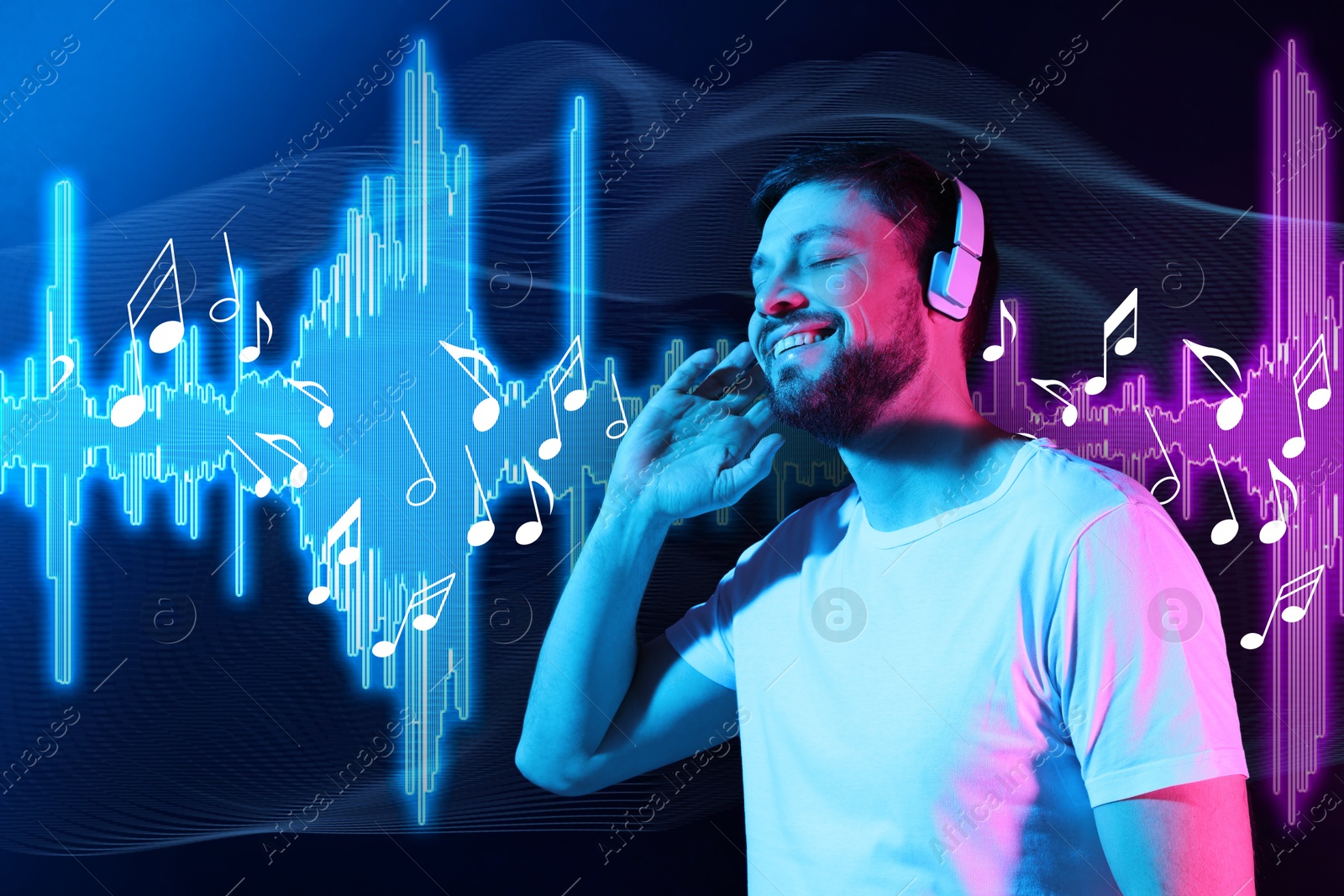 Image of Happy man with headphones in neon lights against dark blue background. Music notes and sound waves near him