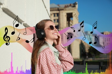 Image of Smiling woman with headphones outdoors. Music notes and sound waves near her