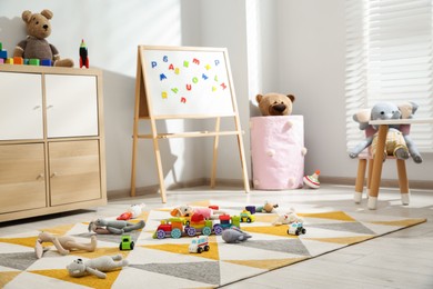 Photo of Beautiful child's room interior with toys and stylish furniture