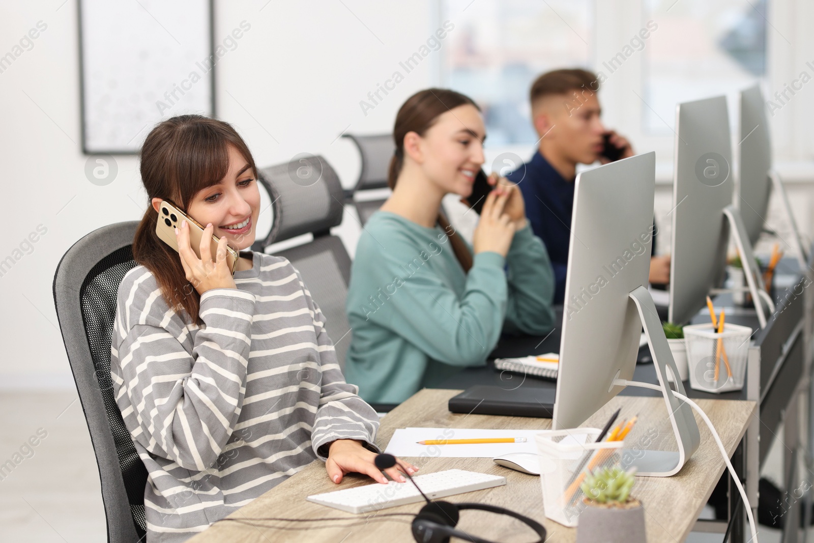 Photo of Sales department. People calling to clients in office, selective focus