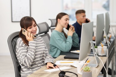 Photo of Sales department. People calling to clients in office, selective focus